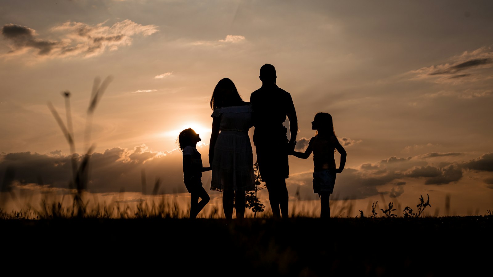 A family embracing outdoors at golden hour